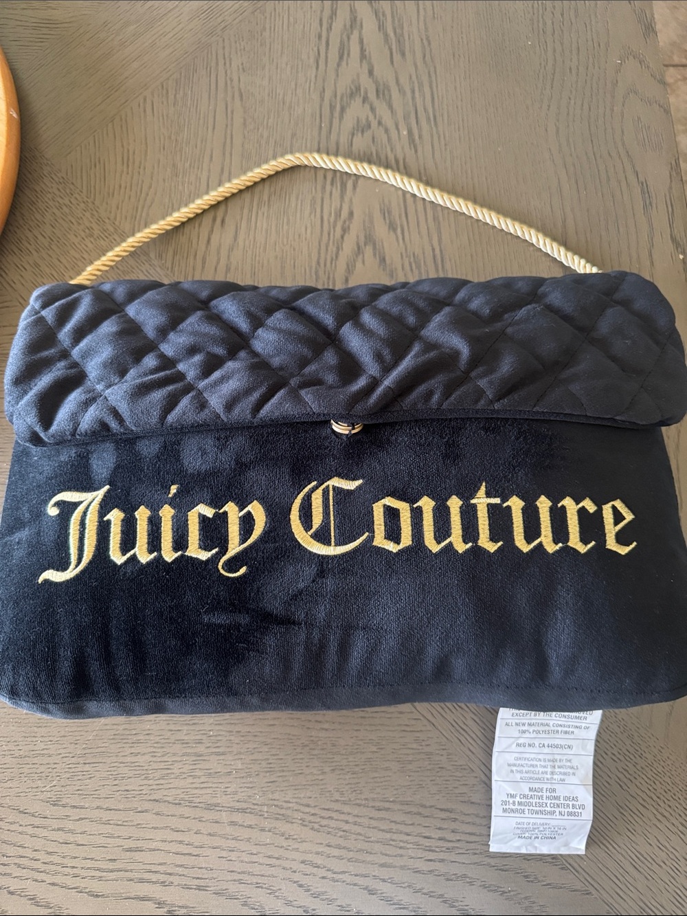 Juicy Couture Black Quilted decorative pillow with Gold Rope Handle and Logo
